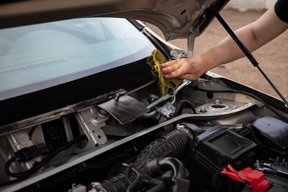 Technician installing new auto glass and performing rock chip repair